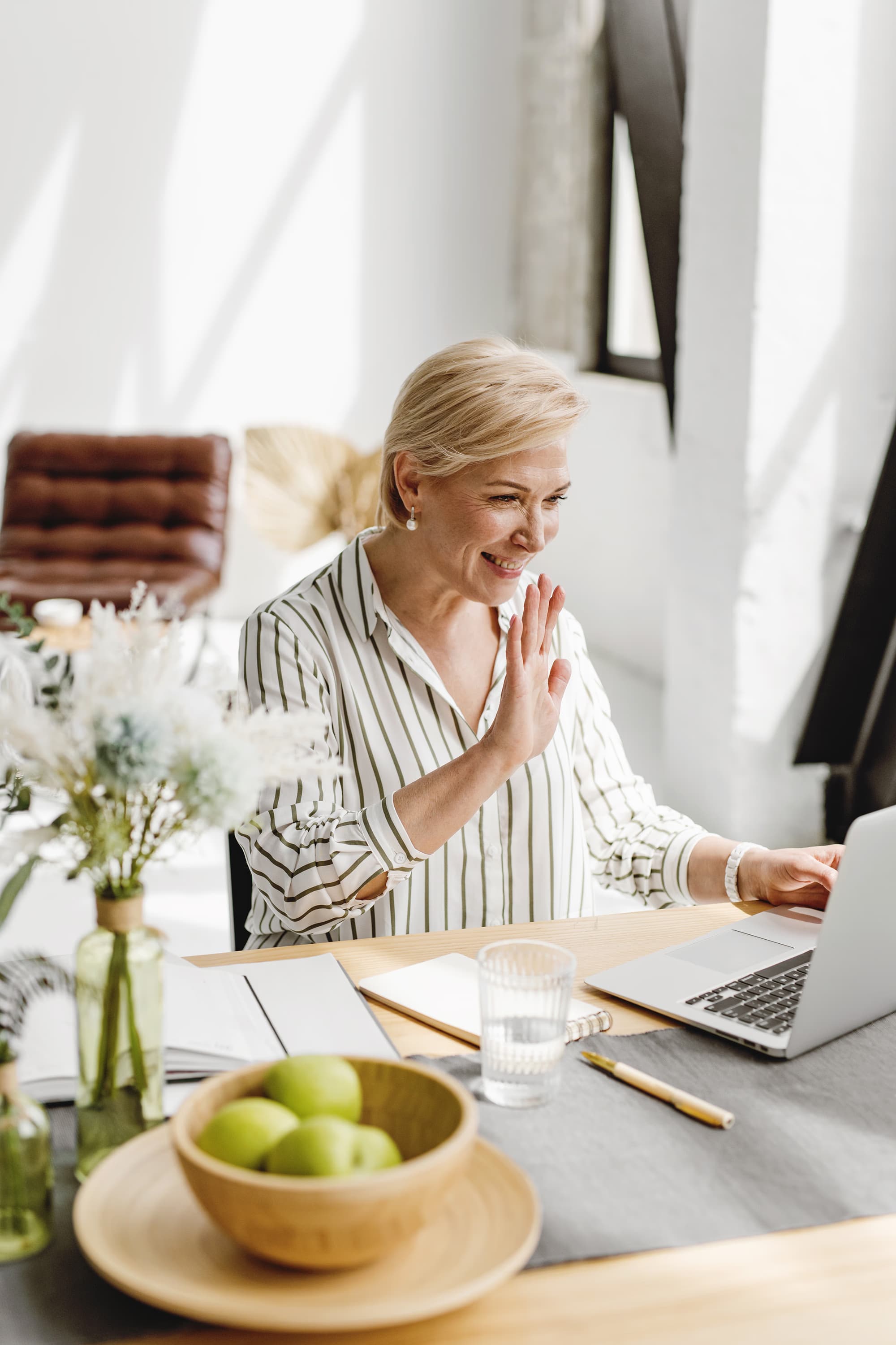 Woman speaking with a clinician during a virtual hormone therapy consultation