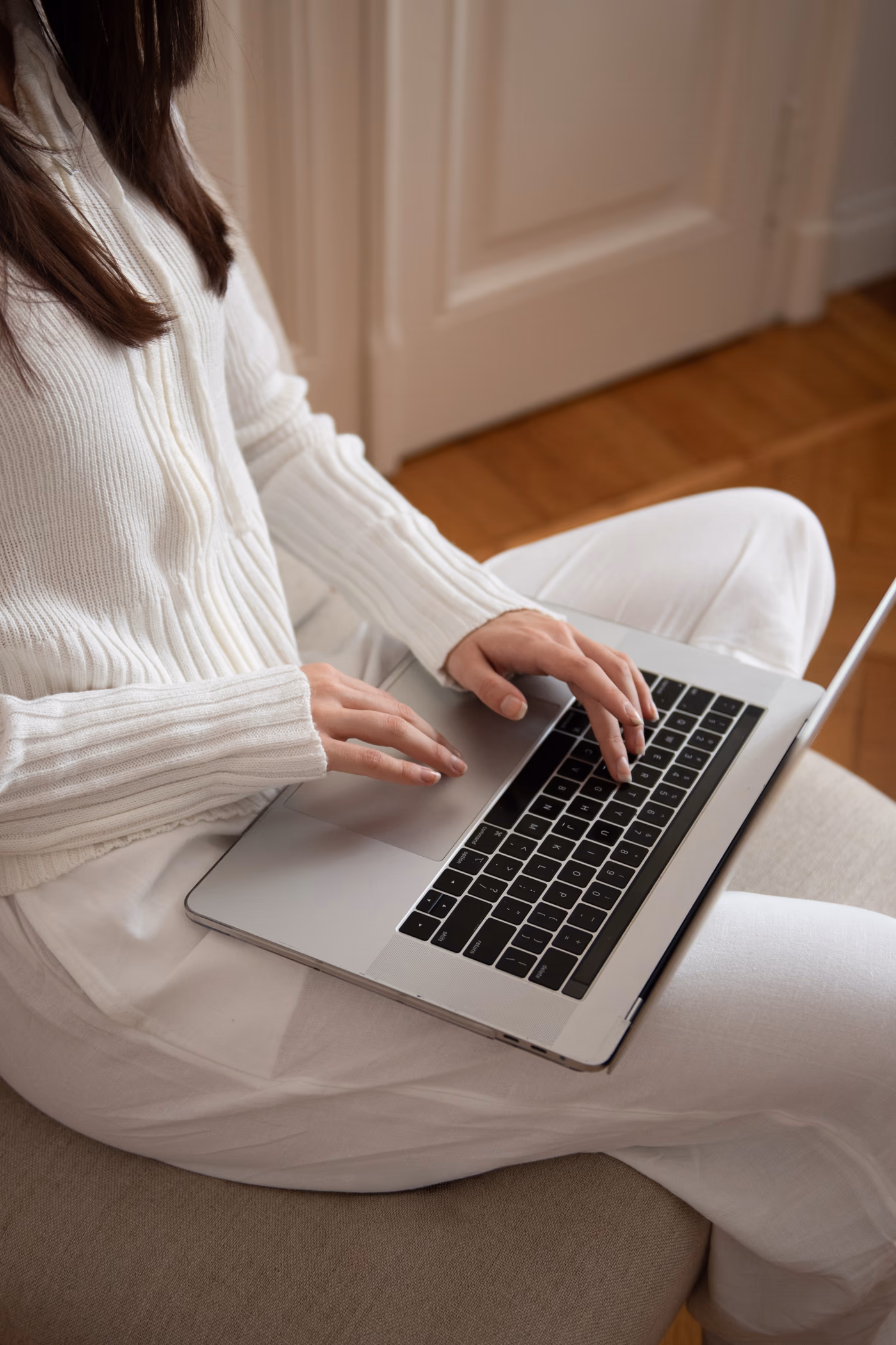 Woman using a laptop while reviewing her care plan